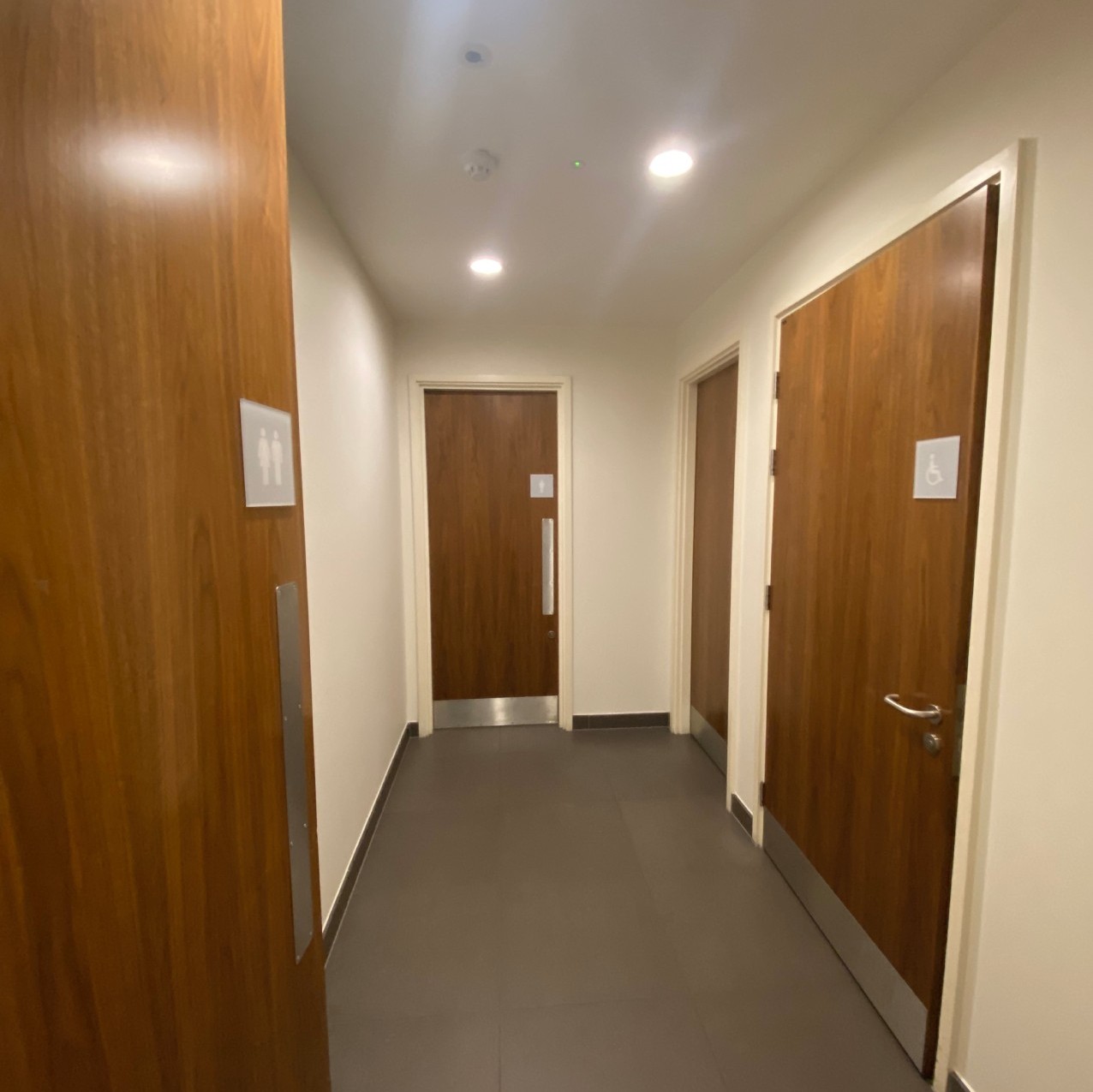 Toilet corridor with doors to accessible, women's and men's toilets